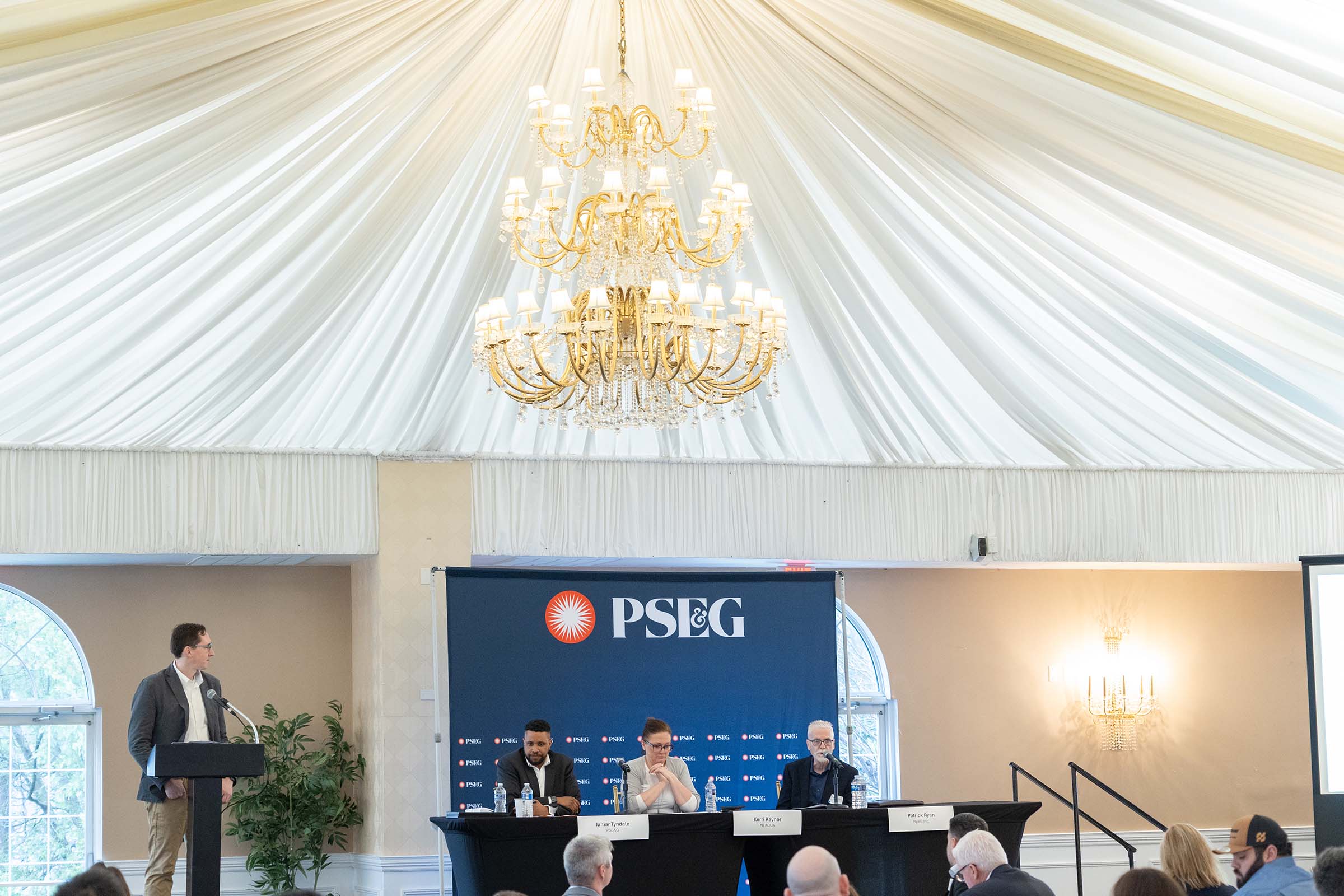 Moderator and panel at corporate conference