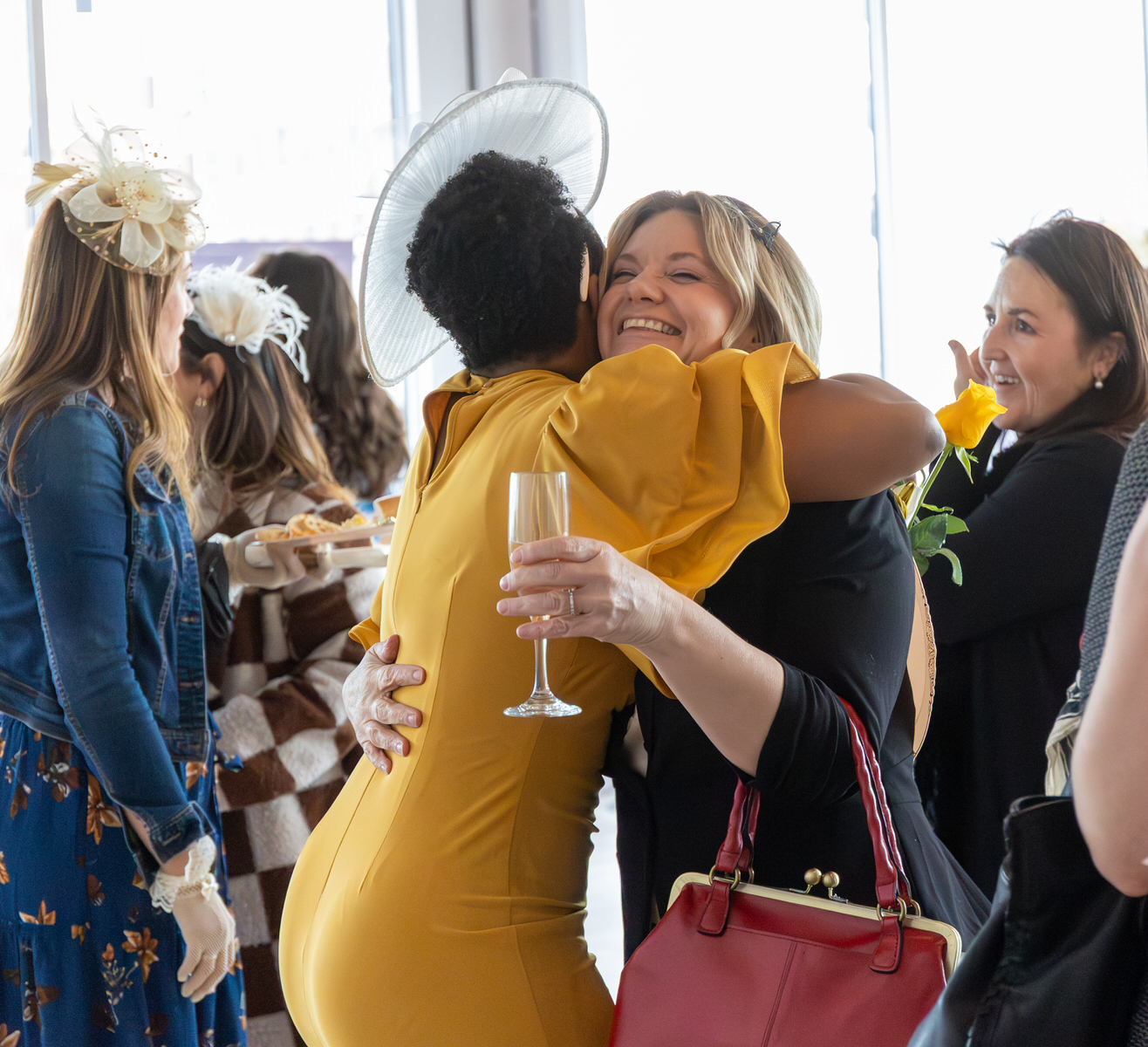 Two woman hugging at business event